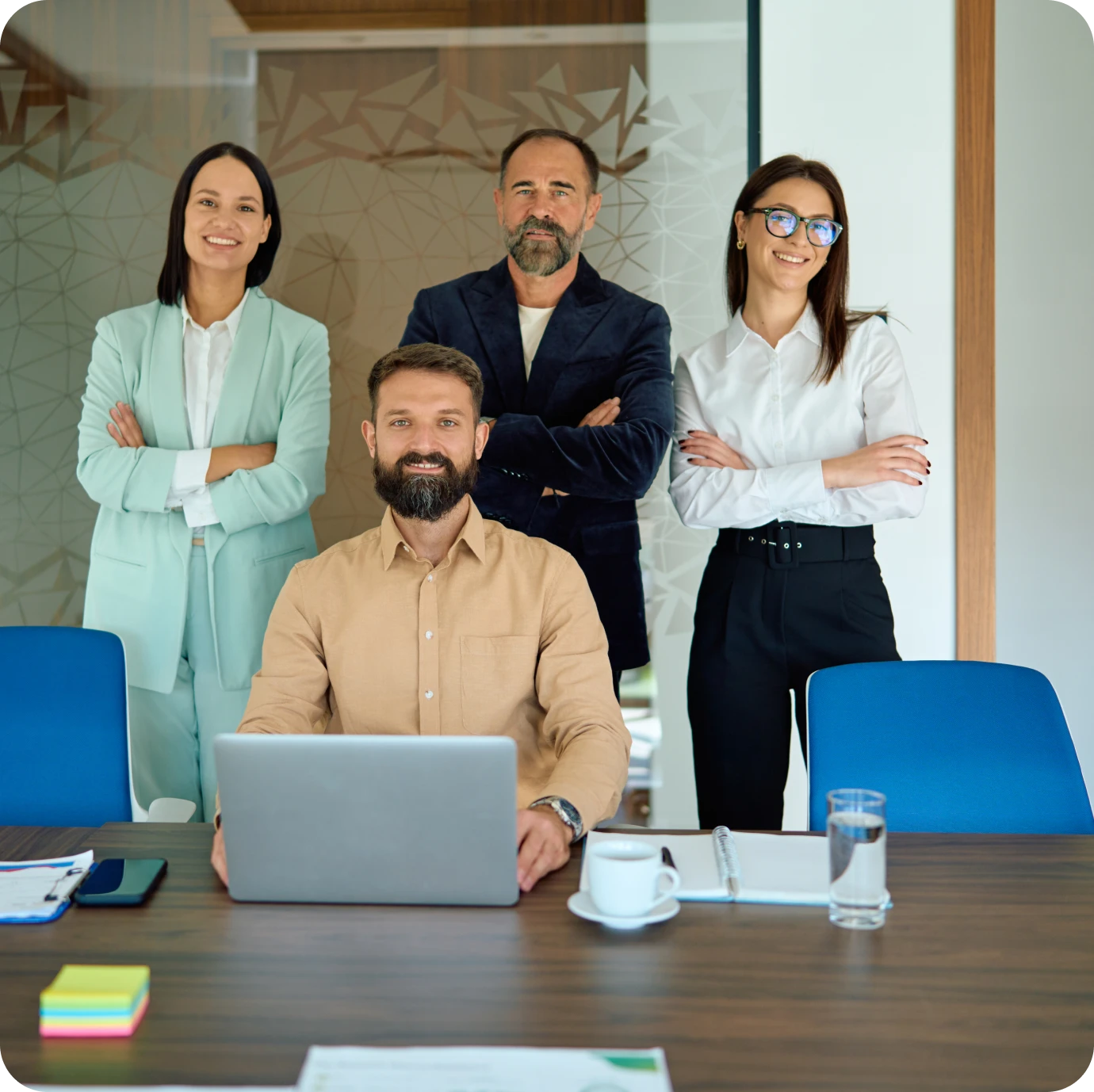 Business team posing confidently at desk