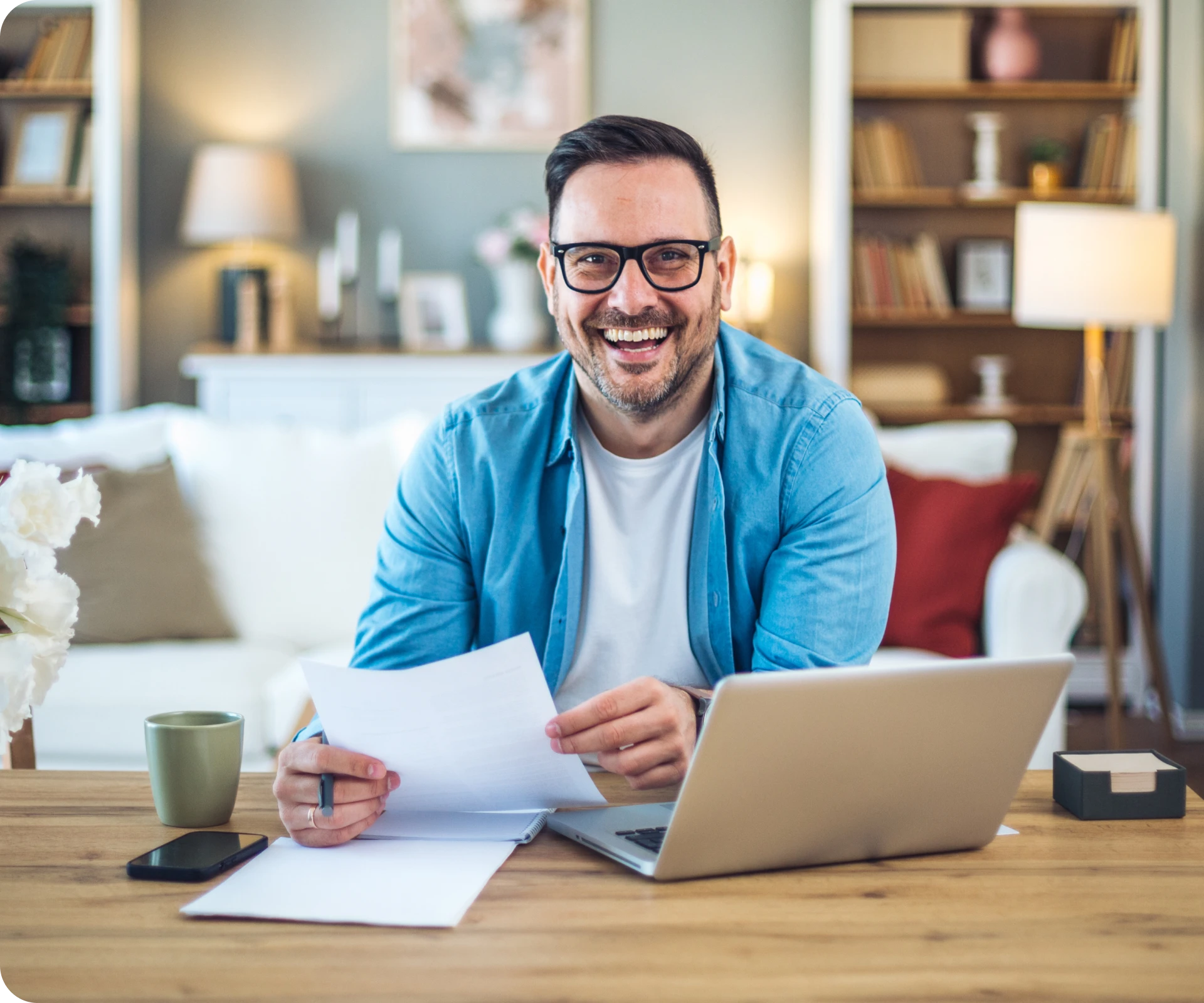 Cheerful person holding papers and laptop