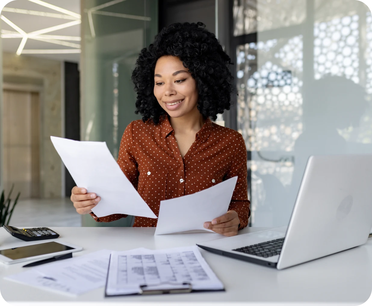 Woman reviewing documents at her desk