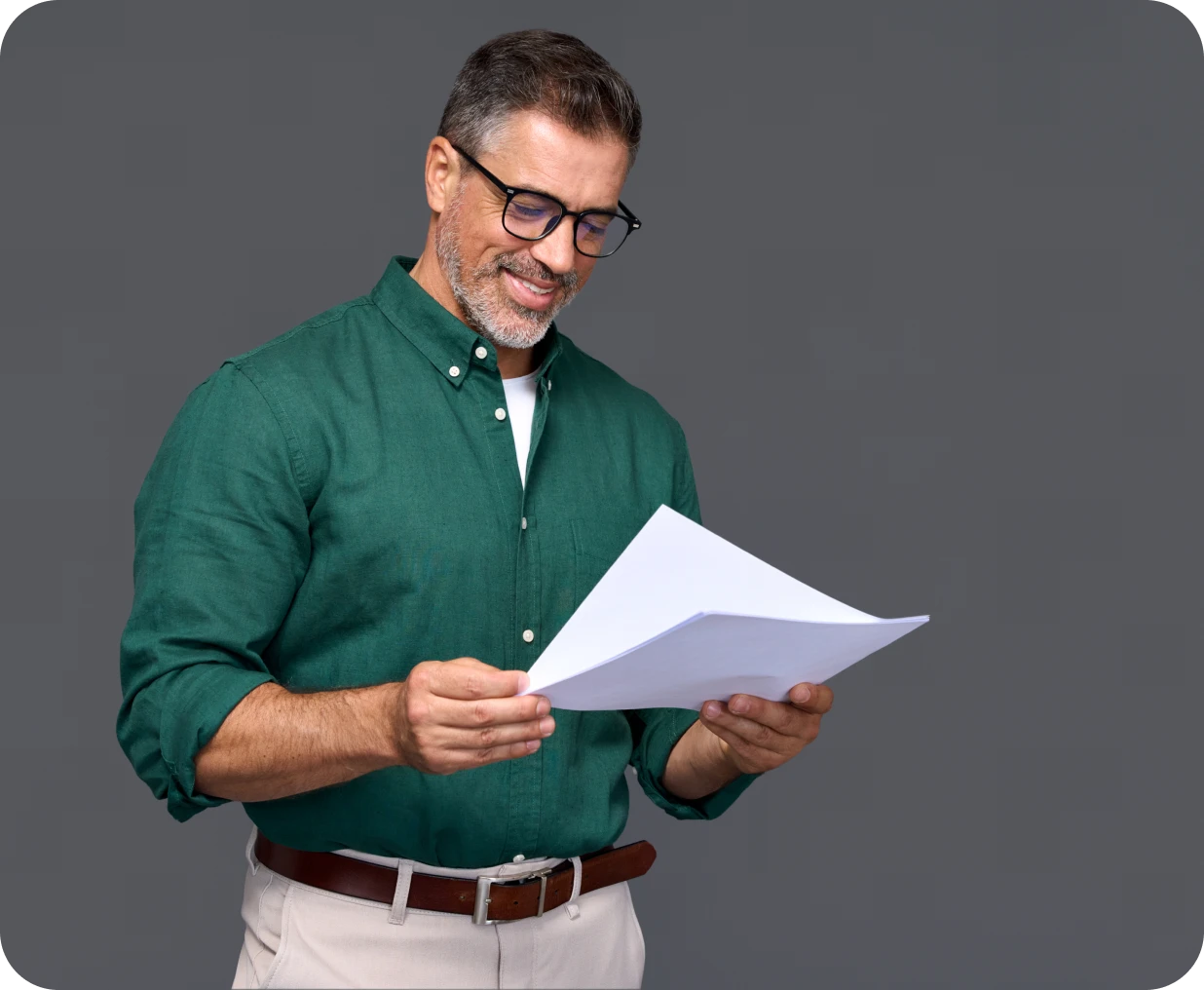 Happy individual reviewing printed sheets